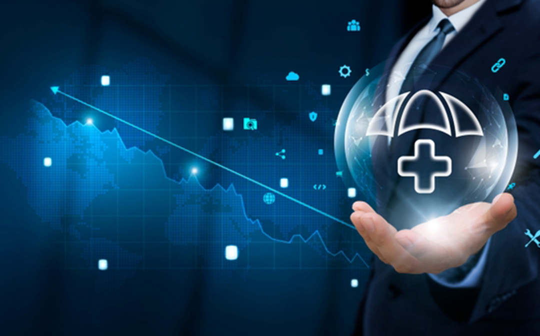 Businessman holding a digital shield with healthcare and cybersecurity icons over a financial graph background, representing modern Cybersecurity Solutions in the healthcare industry.